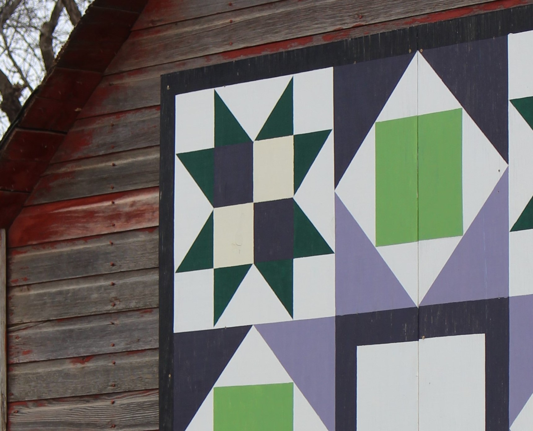 Colorful barn quilt displayed along the Chan SanSan Scenic Backway