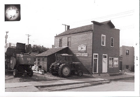 Historic photo of a tractor parked in front of a store